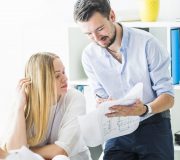 male-female-architect-working-blueprint